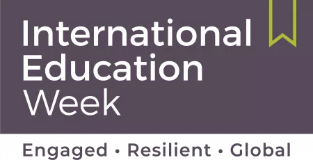 A brown banner with the outline of a green ribbon. Words on the banner read International Education Week; Engaged, Resilient, Global