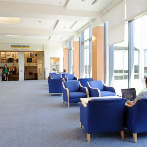 The Haggard Hall skybridge is a cozy space with comfortable blue seating and carpeted halls.