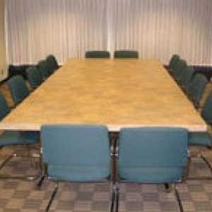 A Viking Union meeting room with a large rectangular table and seating for 12