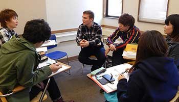 A group of international students work together on their English skills in the classroom
