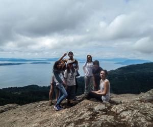 Students on top of a mountain overlooking Bellingham Bay
